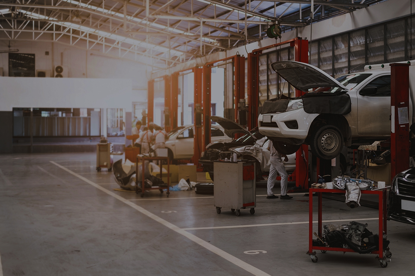 Auto repair shop with mechanics working on vehicles